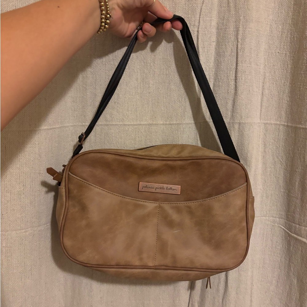Petunia Pickle Bottom Tan and Brown leather diaper clutch bag.